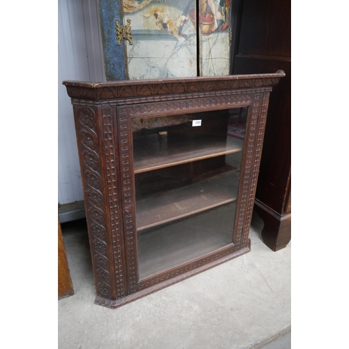 2253 - A Victorian carved oak glazed corner unit