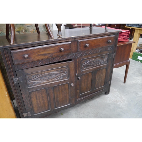 2165 - A carved oak two drawer, two door cupboard