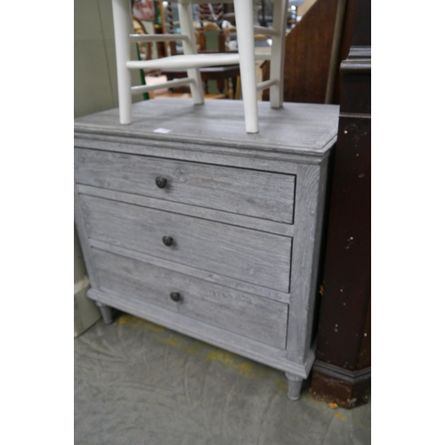 2316 - A lime washed oak chest of three drawers