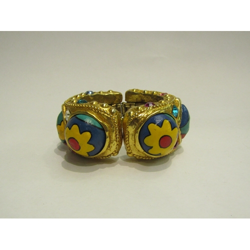 4422 - An Alexis Lahellec, Paris, gilt bangle with painted cabochons and gem stone effect