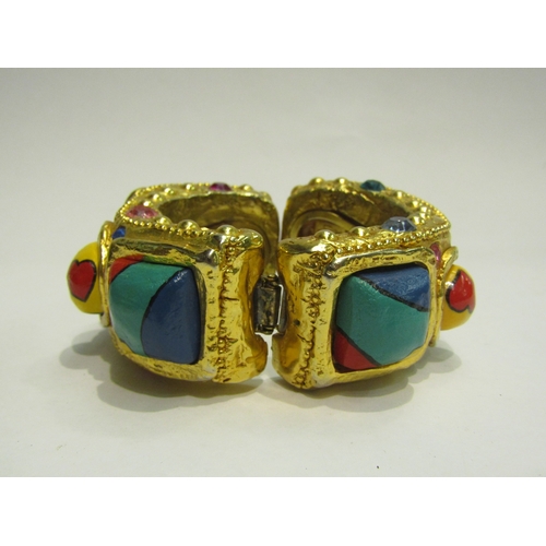 4422 - An Alexis Lahellec, Paris, gilt bangle with painted cabochons and gem stone effect