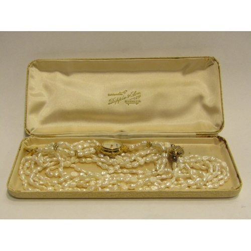 4445 - A six strand cultured rice pearl necklace and similar Monet watch, in cream Dipple & Son box