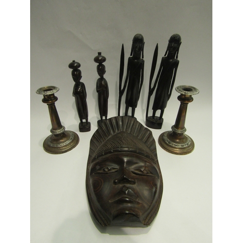 4460 - Four African carved hardwood figures, a mask and a pair of weighted copper candlesticks (7)