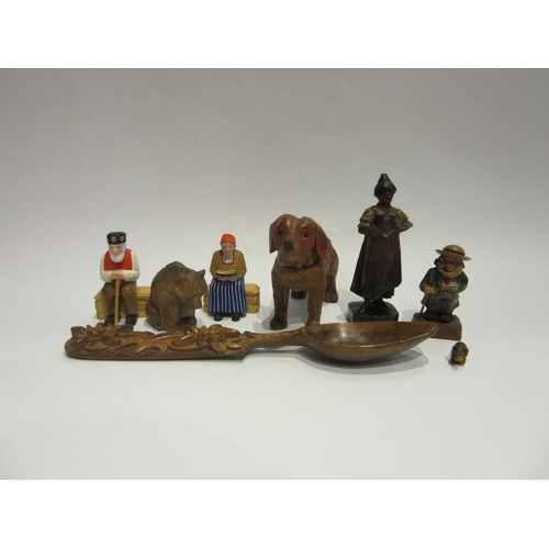 4394 - A selection of Black Forest/chip carved figures and spoon, some painted, including dog, bear, old ge... 