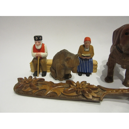 4394 - A selection of Black Forest/chip carved figures and spoon, some painted, including dog, bear, old ge... 