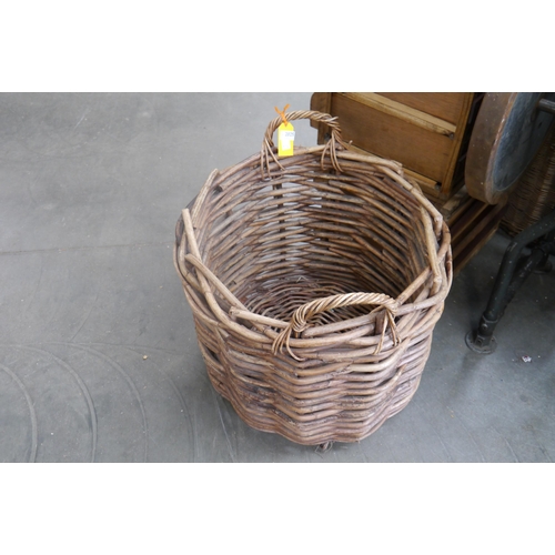 2025 - A large wicker log basket with twin handles