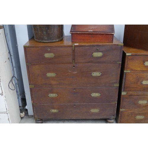 2104 - A 19th Century mahogany campaign chest of two over three drawers with brass handles and mounts, in t... 