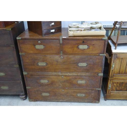 2105 - A 19th Century mahogany campaign chest of two over three drawers with brass handles and mounts, in t... 