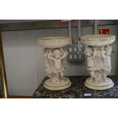 2114 - A pair of resin plant stands with children holding bowl aloft