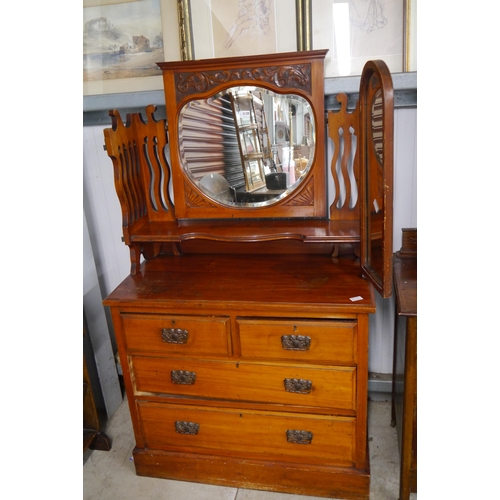 2128 - An Edwardian walnut dressing chest, the mirrored gallery back with foliate carving over two short an... 