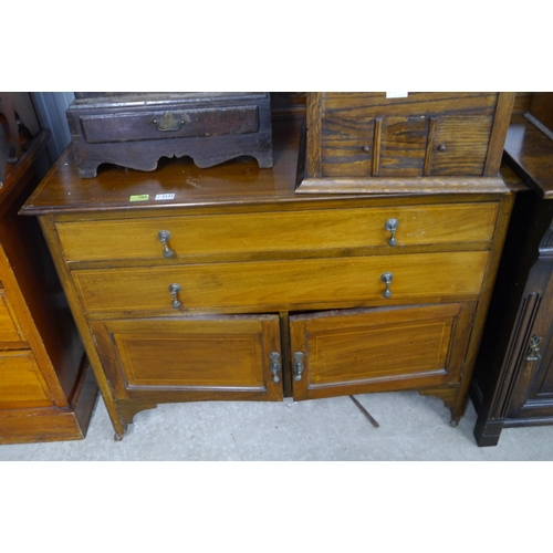 2131 - An Edwardian mahogany two drawer over two door cupboard