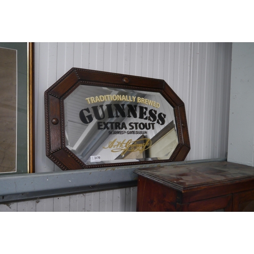 2170 - An oak framed mirror with later painted 'Guinness Extra Stout' to glass