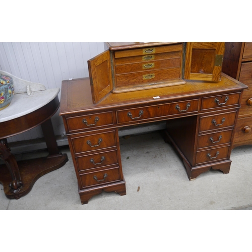 2180 - A reproduction mahogany twin pedestal desk with brown leather top