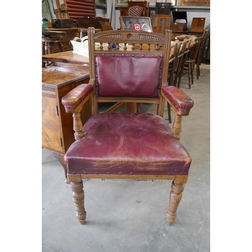 2239 - A late 19th Century oak and red leather desk chair