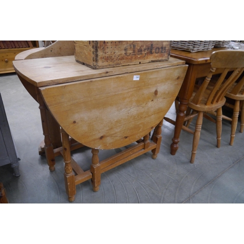 2307 - A stripped pine drop leaf gate legged table