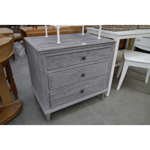 2316 - A lime washed oak chest of three drawers