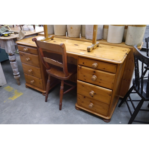 2380 - A modern pine dressing table / desk with eight frieze drawers, turned handles