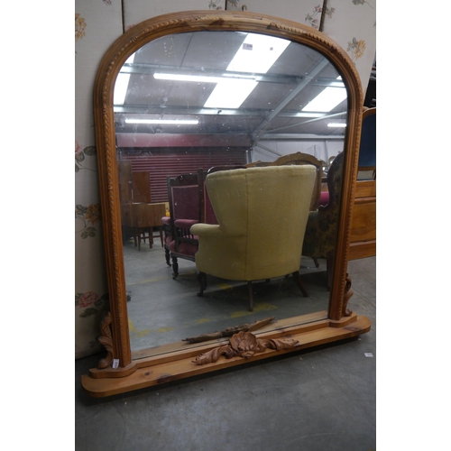 2396 - A Victorian style pine overmantel mirror with carved crest