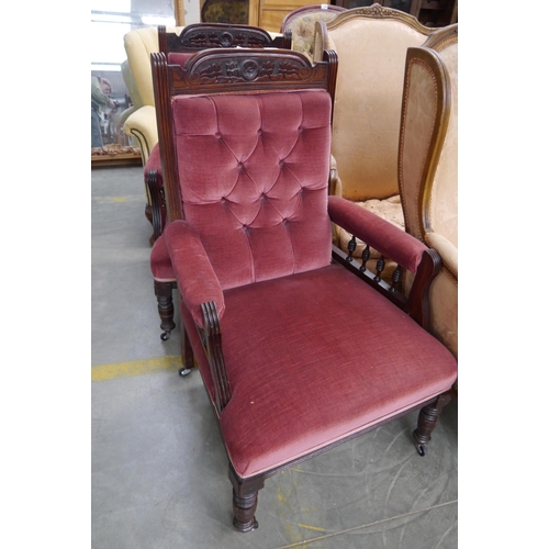 2408 - A pair of late Victorian deep-seated armchairs, buttoned pin upholstery, carved relief