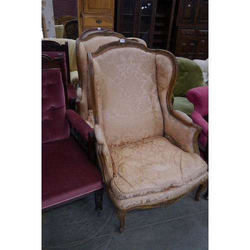 2409 - A pair of French wing back armchairs