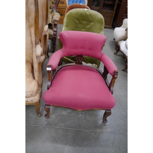 2410 - An Edwardian mahogany nursing chair, red upholstery and pierced slats on cabriole legs