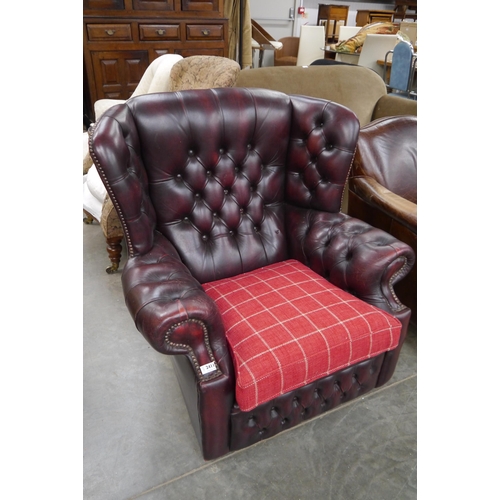 2411 - A red leather Chesterfield armchair