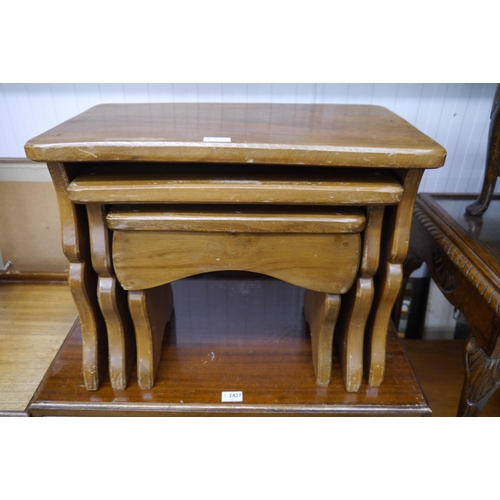 2426 - A nest of three fitting tables, sewing box, table and chair