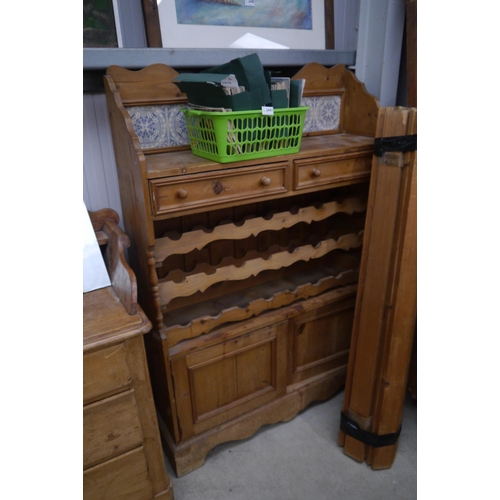 2438 - A pine kitchen unit on plinth base with wine rack, two drawers to top and two doors to base, a/f wat... 