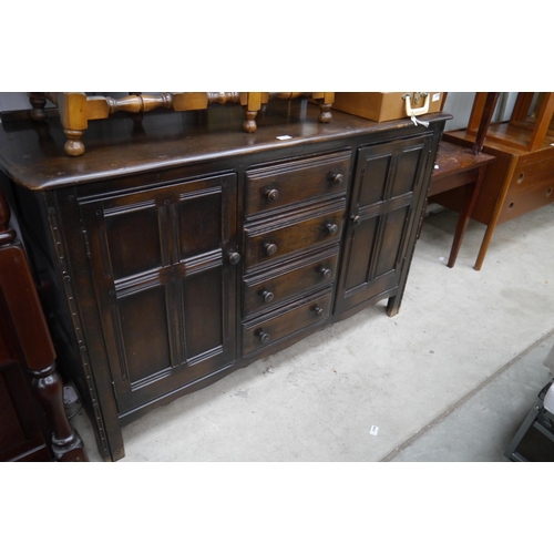 2468 - An Ercol two door, four drawer sideboard