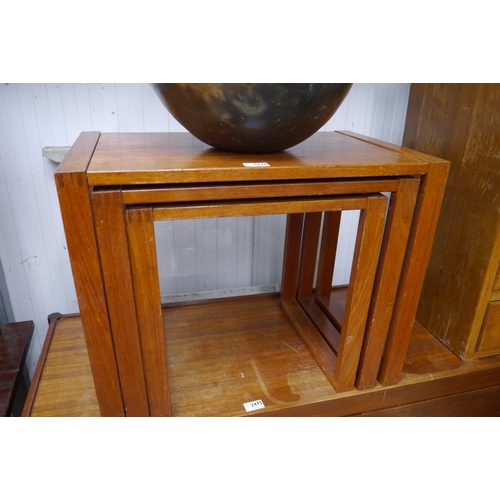 2476 - A set of three teak nesting tables