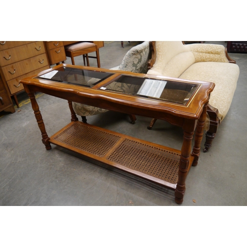 2513 - A bevelled glass top side unit with rattan undertier