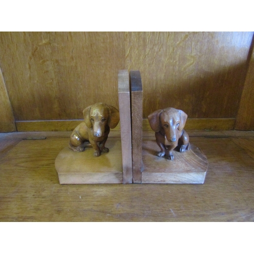 4007 - A pair of Dachshund chip carved bookends, 15.5cm tall