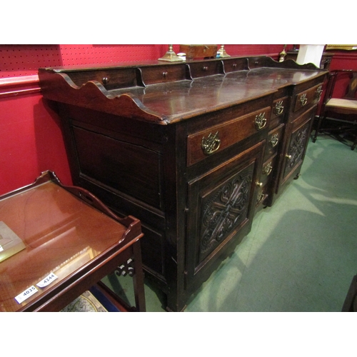 4043 - An 18th Century provincial oak dresser base of inverted breakfront form, with five small drawers to ... 