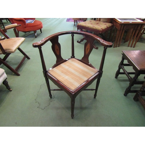 4058 - A pair of mahogany corner chairs on turned supports united by a turned 