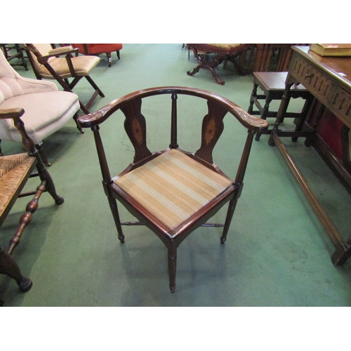 4058 - A pair of mahogany corner chairs on turned supports united by a turned 