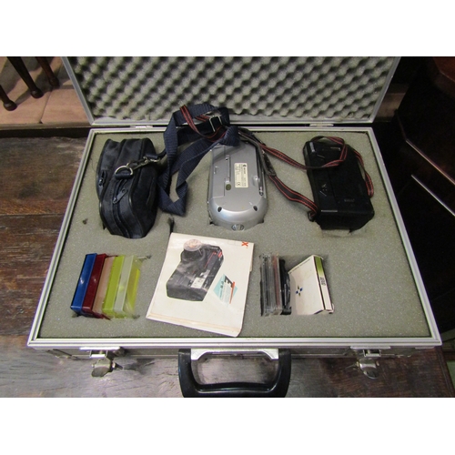 4255 - A hardshell camera case with instant camera, a portable CD player and wind up radio etc.