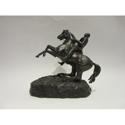 4509 - A cast metal rearing horse figure, 17.5cm tall