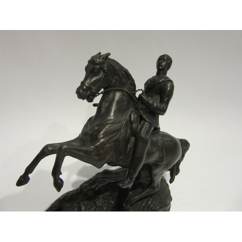 4509 - A cast metal rearing horse figure, 17.5cm tall