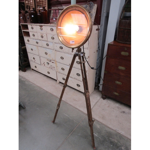 2089 - A vintage brass Lucas car lamp on an oak tripod stand as a lounge lamp