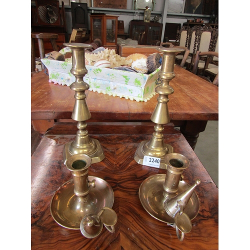 2240 - A pair of brass ejector chamber sticks with snuffers and a pair of candle sticks