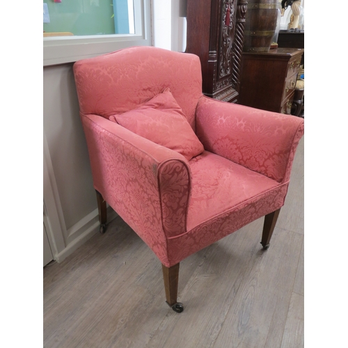 6049 - An Edwardian upholstered armchair, raised upon tapering square section legs