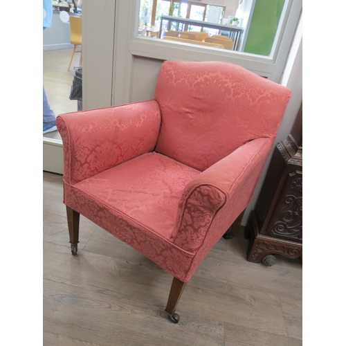 6049 - An Edwardian upholstered armchair, raised upon tapering square section legs