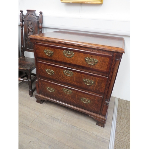 6029 - An early Georgian oak straight front chest of three long graduated drawers flanked by graduated draw... 