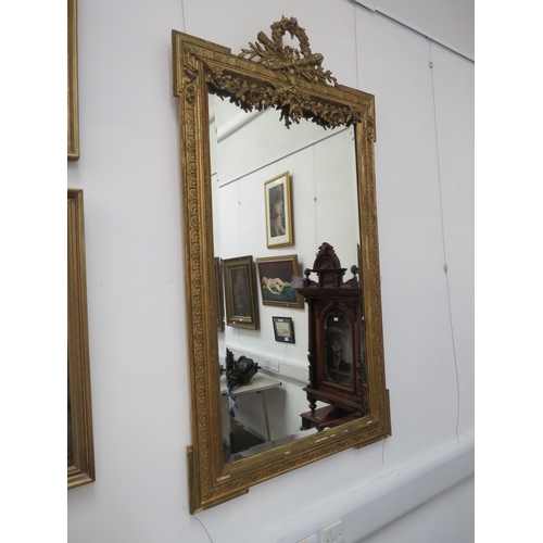 6101 - A classical gilt wooden framed pier mirror with floral garland embellishment, some areas of damage, ... 