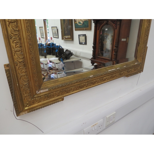 6101 - A classical gilt wooden framed pier mirror with floral garland embellishment, some areas of damage, ... 