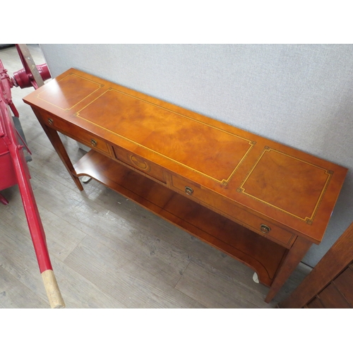 6055 - A 20th/21st Century George III style walnut slim side table with two drawers and an under-tier.  72.... 