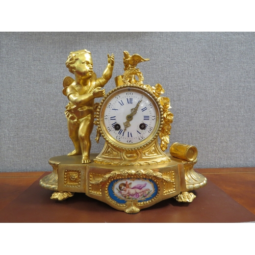 6054 - A 19th Century French ormolu mantel clock, the case surmounted by angel, bird, roses and drum.  Two ... 