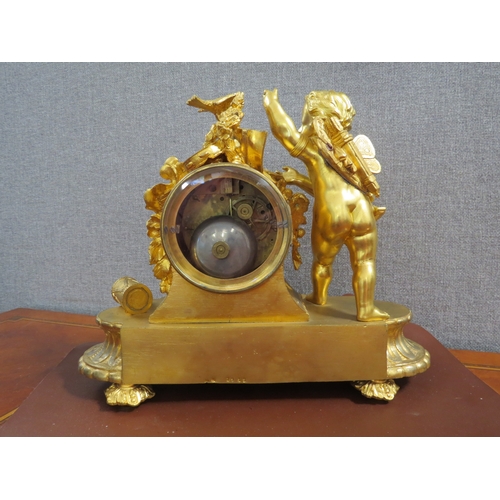 6054 - A 19th Century French ormolu mantel clock, the case surmounted by angel, bird, roses and drum.  Two ... 