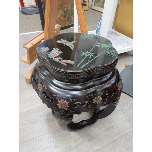 6007 - A shaped top Oriental ebonised occasional table with painted and carved decoration having fretwork d... 