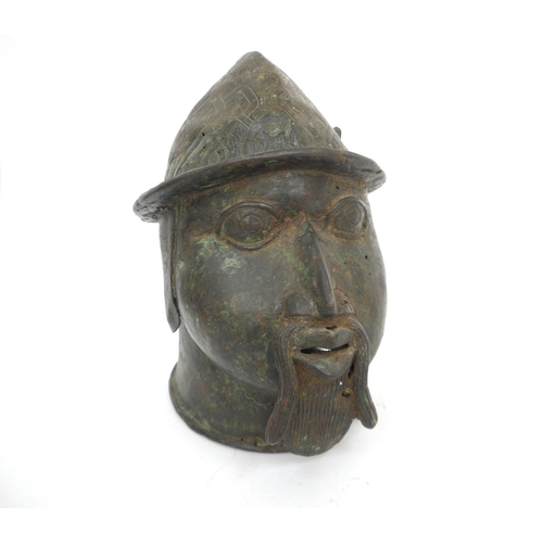 6315 - An African Benin bronze head of a Portuguese soldier, holes present to casting. 22cm x 12cm x 18cm